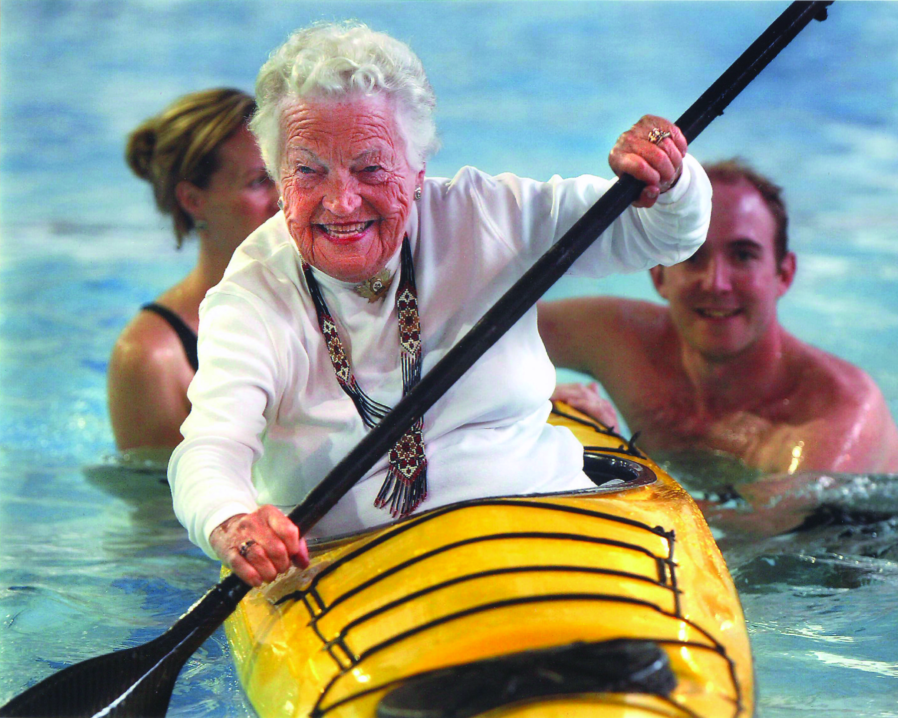 Hazel McCallion holding a paddle aboard a boat.
