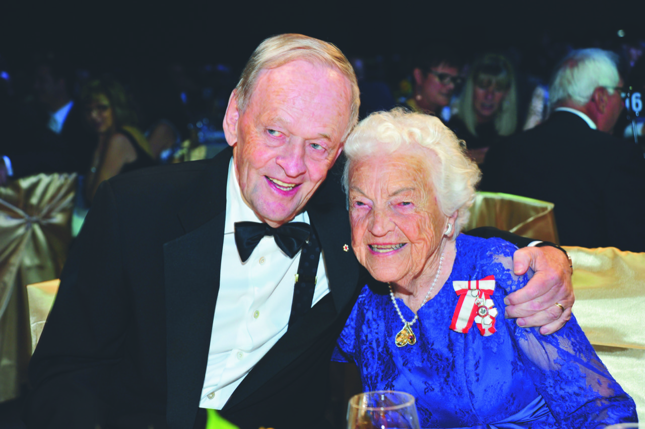 Hazel McCallion, wearing the Order of Canada insignia, seated beside Jean Chrétien at a black-tie event.